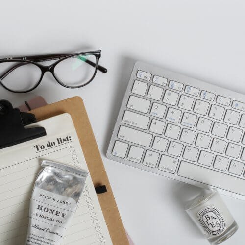 Monochrome Office Flat Lay with Glasses, To Do List and Diptyque Candle
